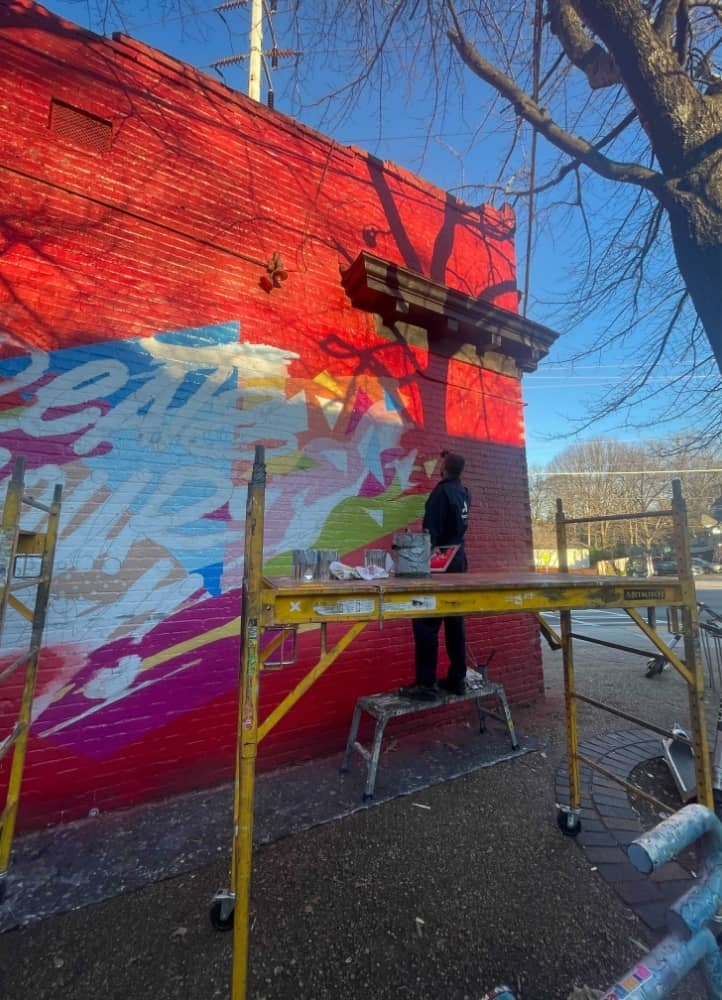 Brighter Community Atlanta one person painting on the side of a building