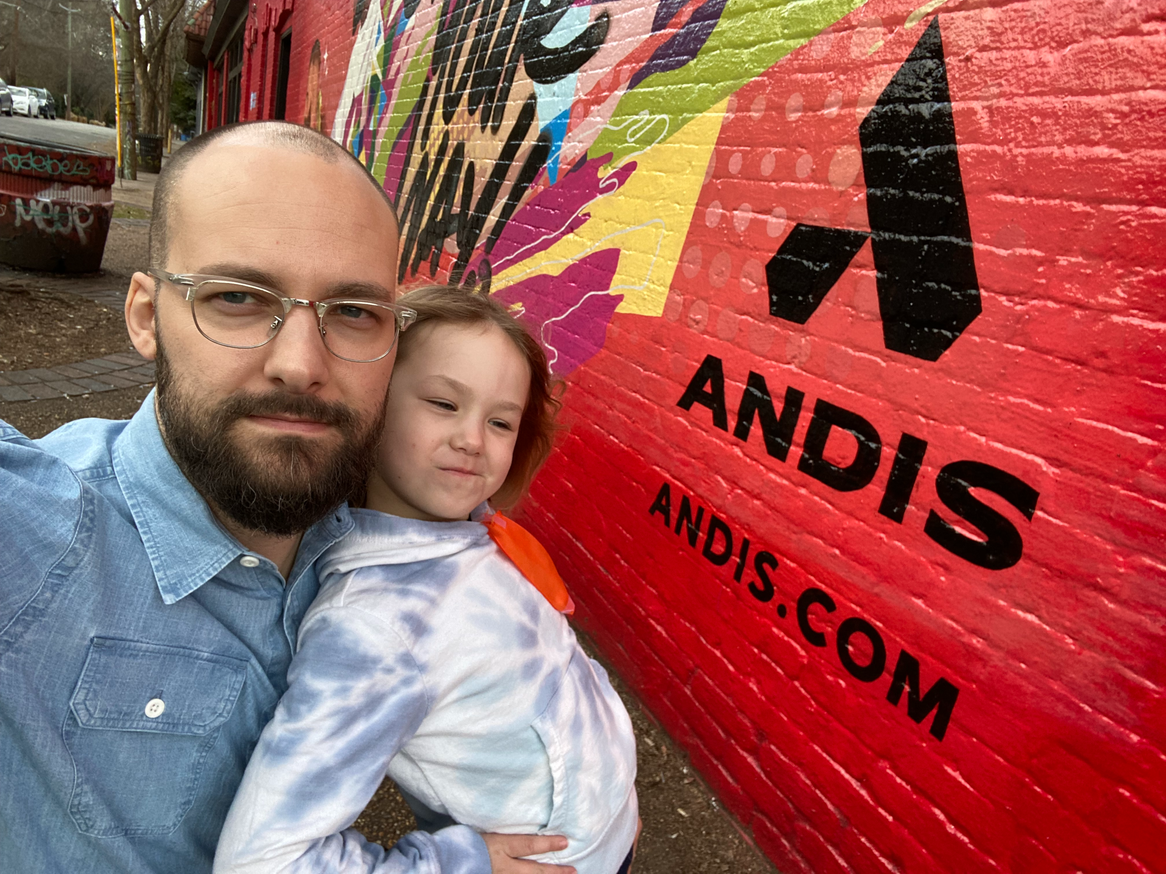 Brighter Community Atlanta Kenny Duncan leaning against wall mural