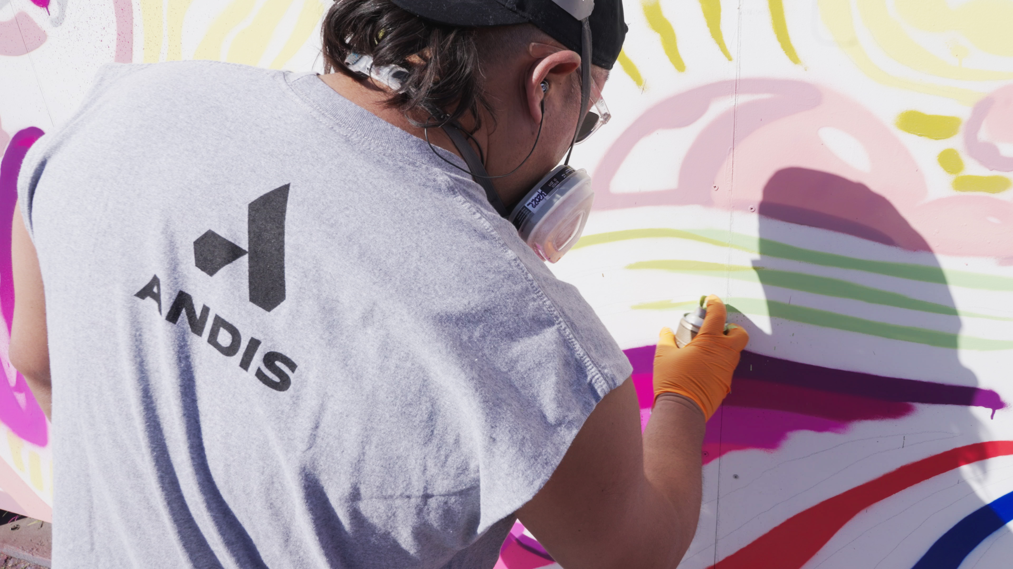 Brighter Community Venice Beach man spray painting on mural in green