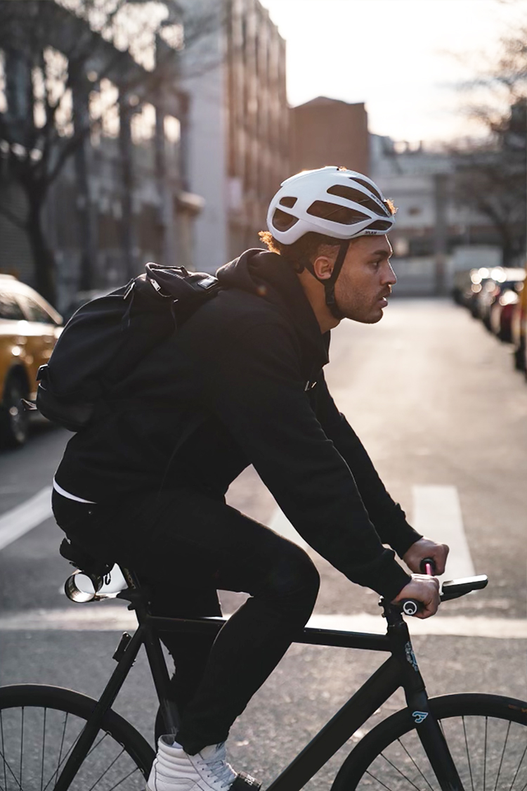 Close up of Julien Howard a.k.a. Velo Barber riding bike on busy urban street